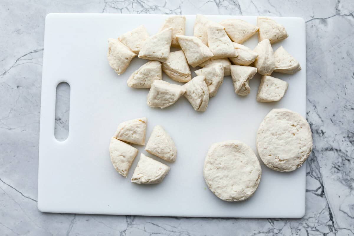 Overhead shot o cut up biscuits on cutting board. 