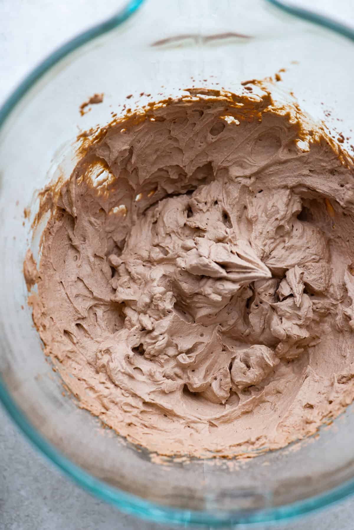 Overhead shot of chocolate whipped cream in glass bowl. 