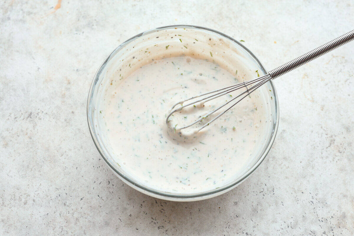 Dressing ingredients mixed with a whisk. 