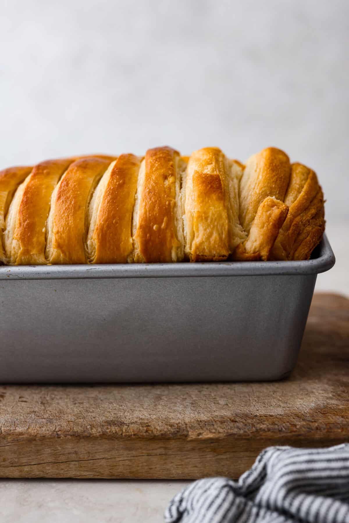 Side shot of baked croissant bread with browned top. 