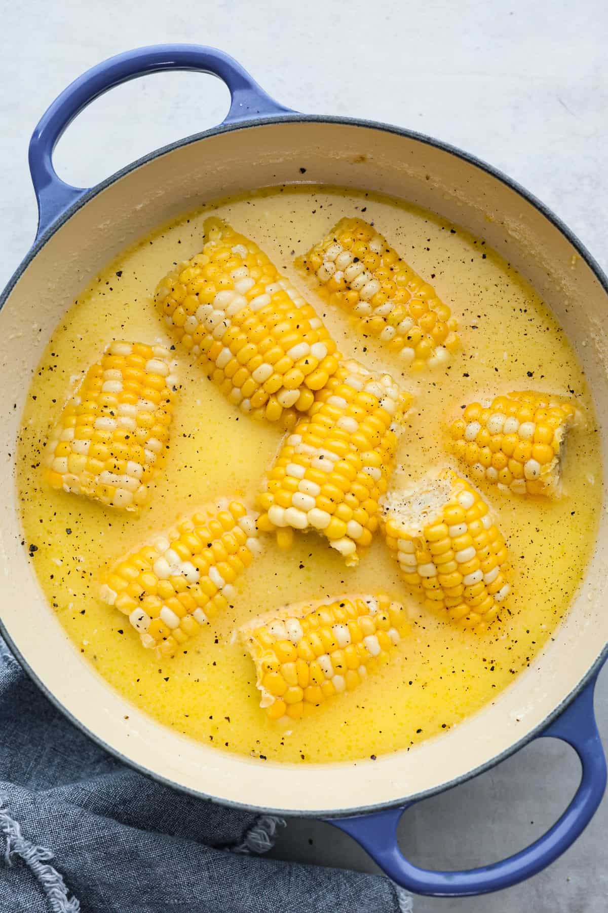 Top view of boiled corn on the cob in a pot.