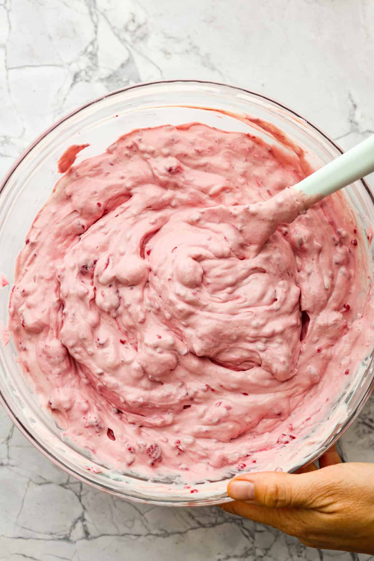 The top view of all of the ingredients mixed together in a glass bowl. 