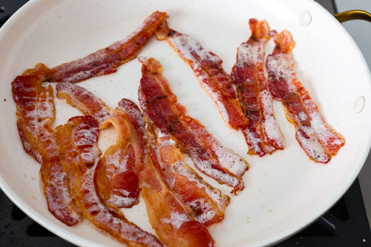 The bacon for the sheet pan eggs being cooked.