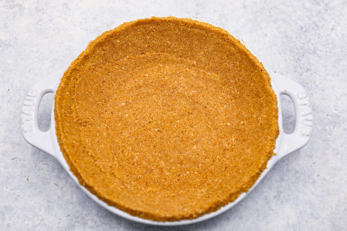 Overhead shot of crust pressed into a pie dish. 