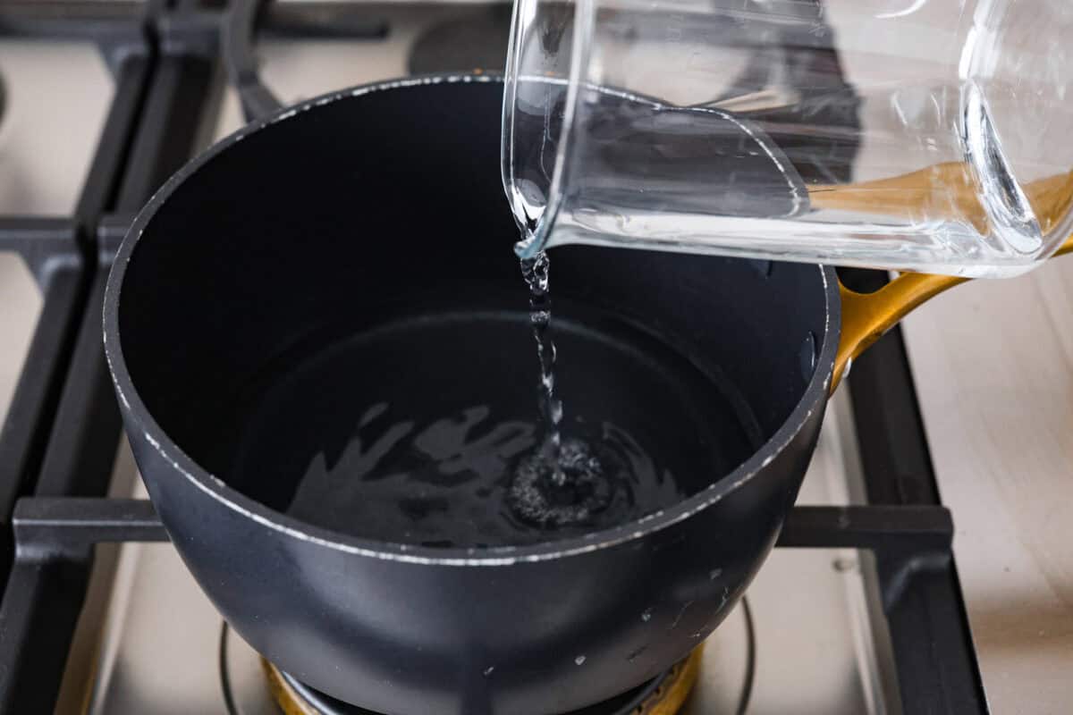 First photo of water adding to a pot to make a double boiler.