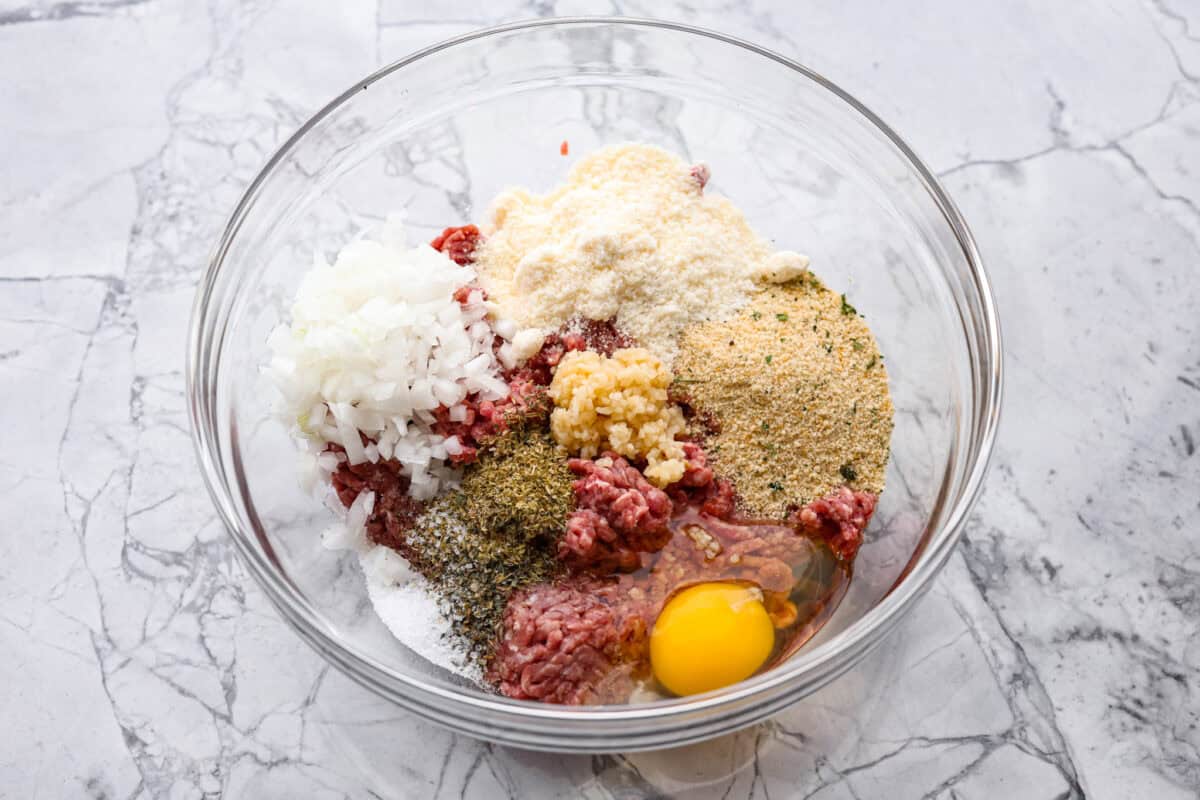 First photo of meatball ingredients added to a bowl.