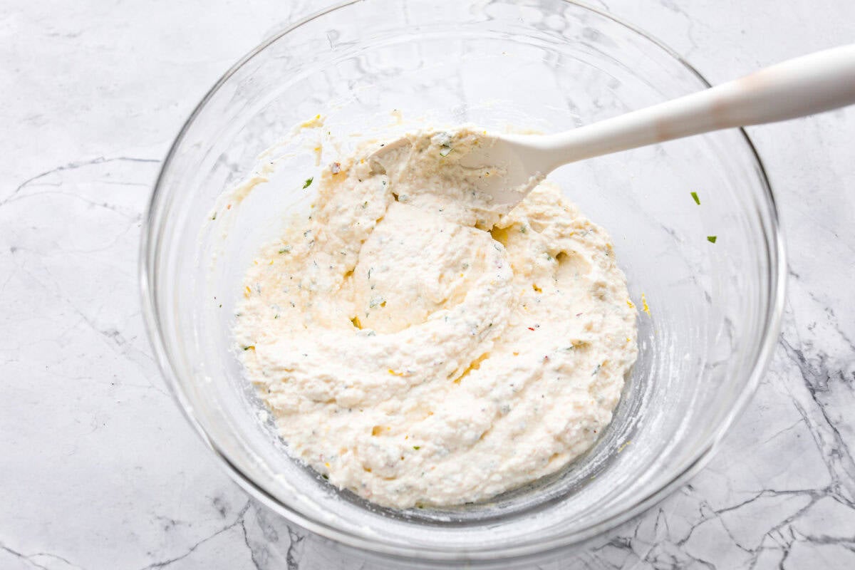 Overhead shot of ingredients stirred up in a glass bowl.