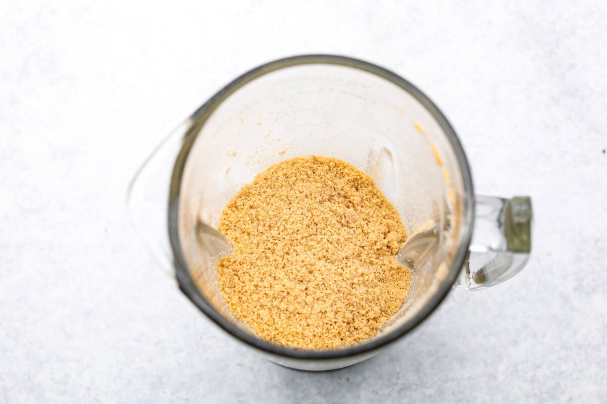 Overhead shot of oatmeal cookie crumbs in a blender. 