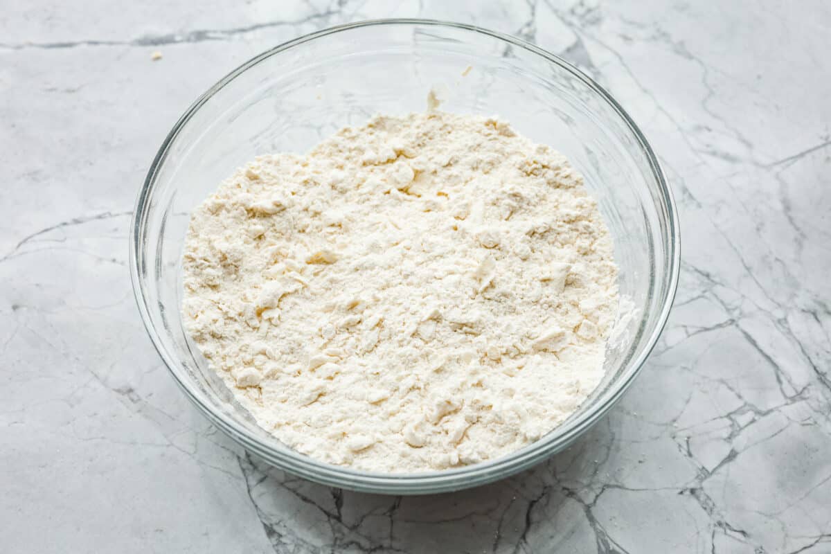 Overhead shot of flour mixture combined with the butter and cream cheese. 