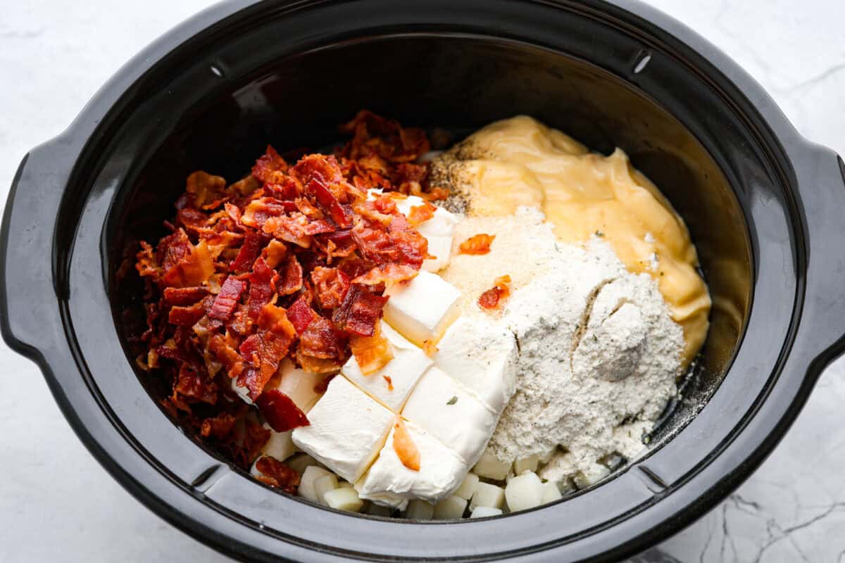 Overhead shot of ingredients dumped in a crock pot. 