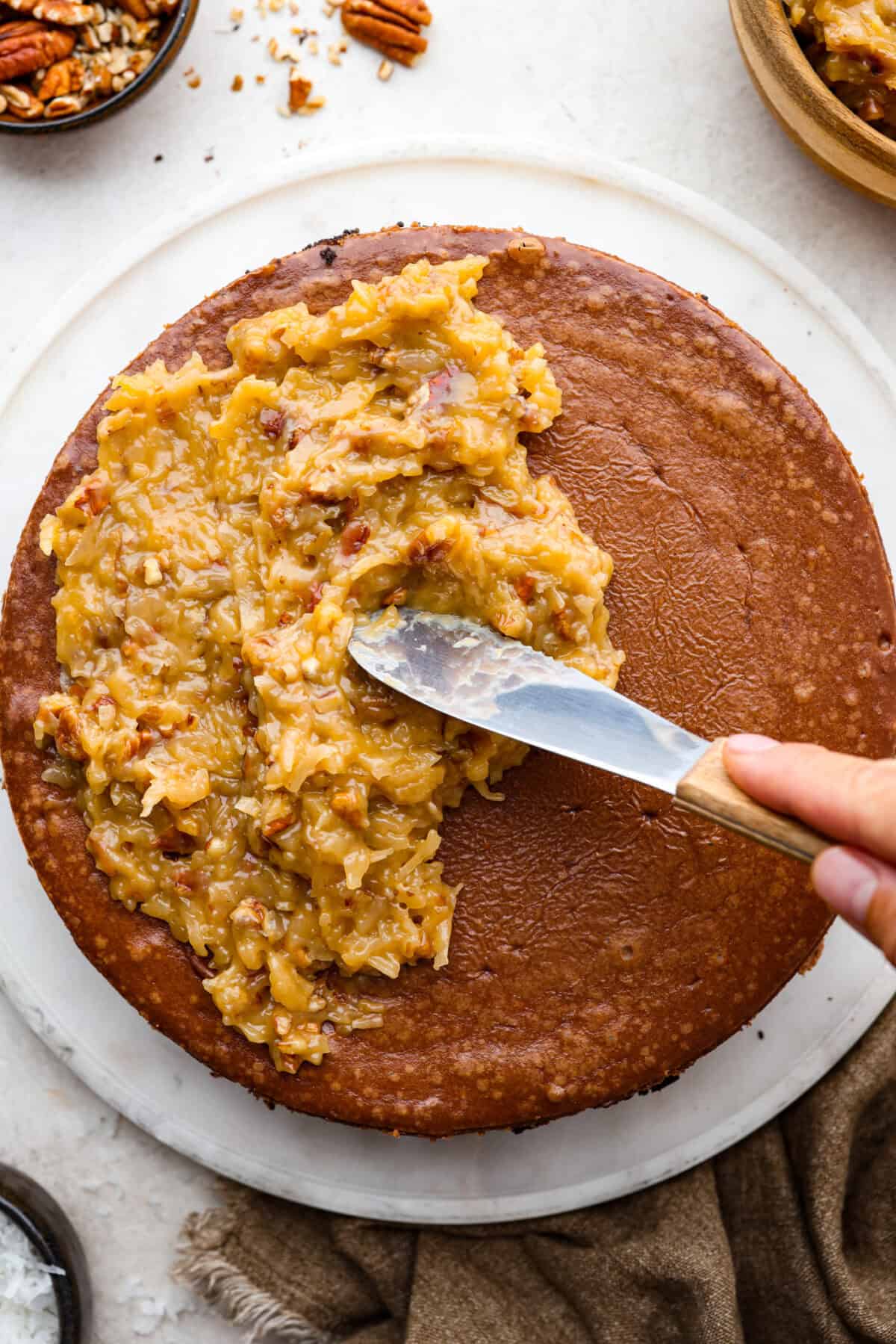 Top close view of the German topping spreading on top of the German Chocolate cheesecake.