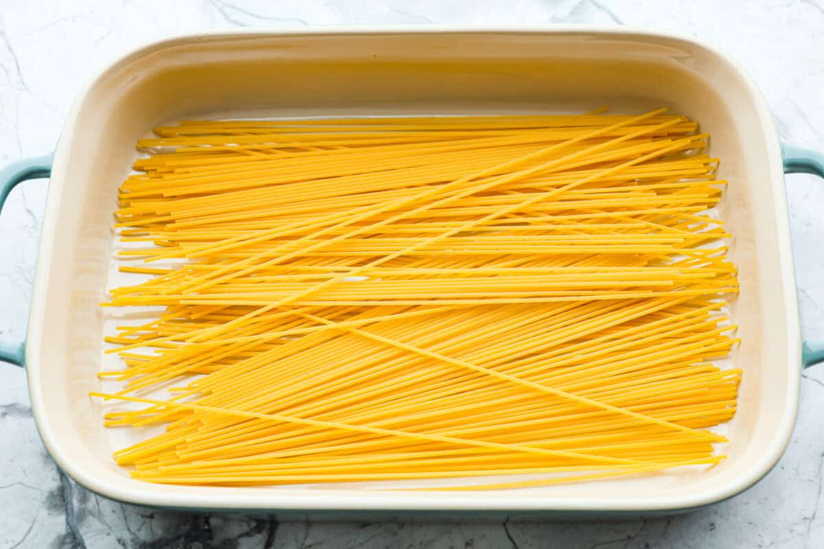 Overhead shot of noodles in the bottom of a baking dish. 