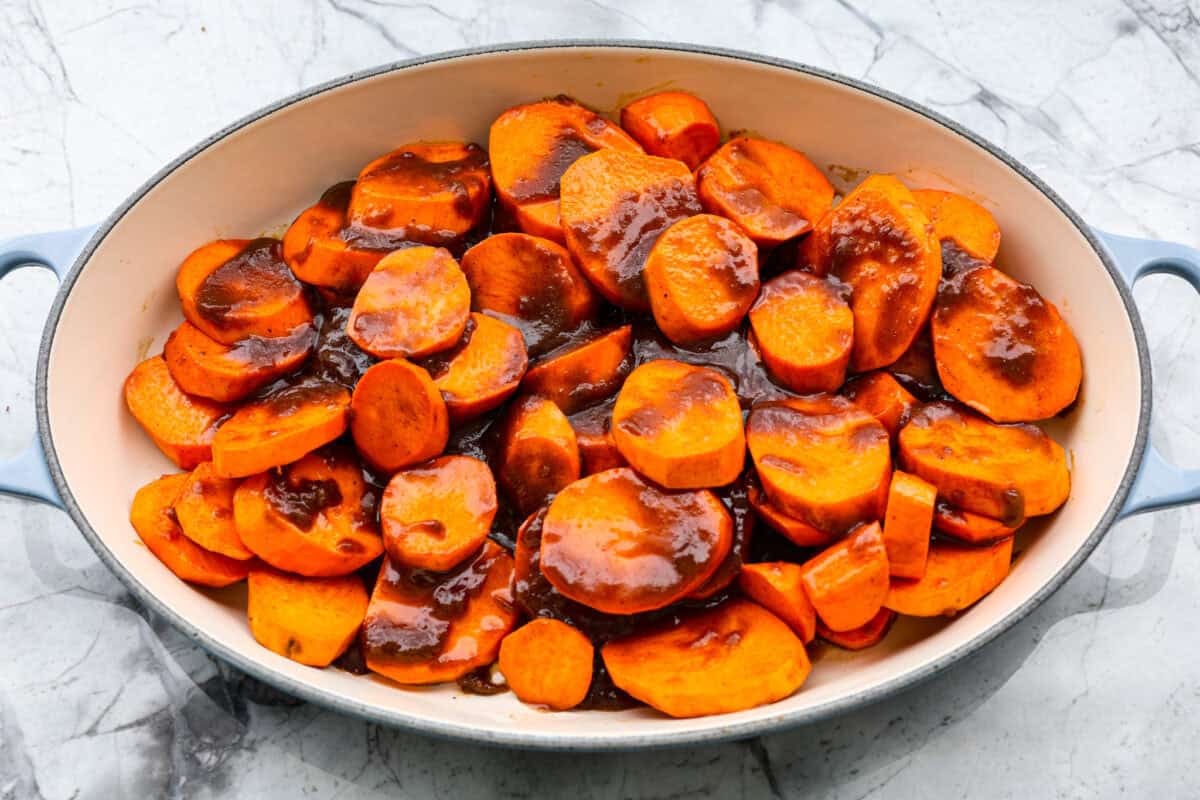 Overhead shot of sliced yams with sugar and butter mixture spread over the top. 