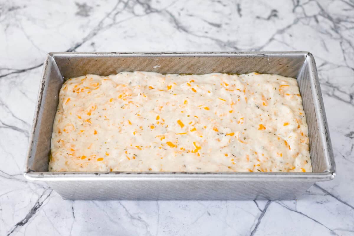 Angle shot of bread batter in the bread pan. 