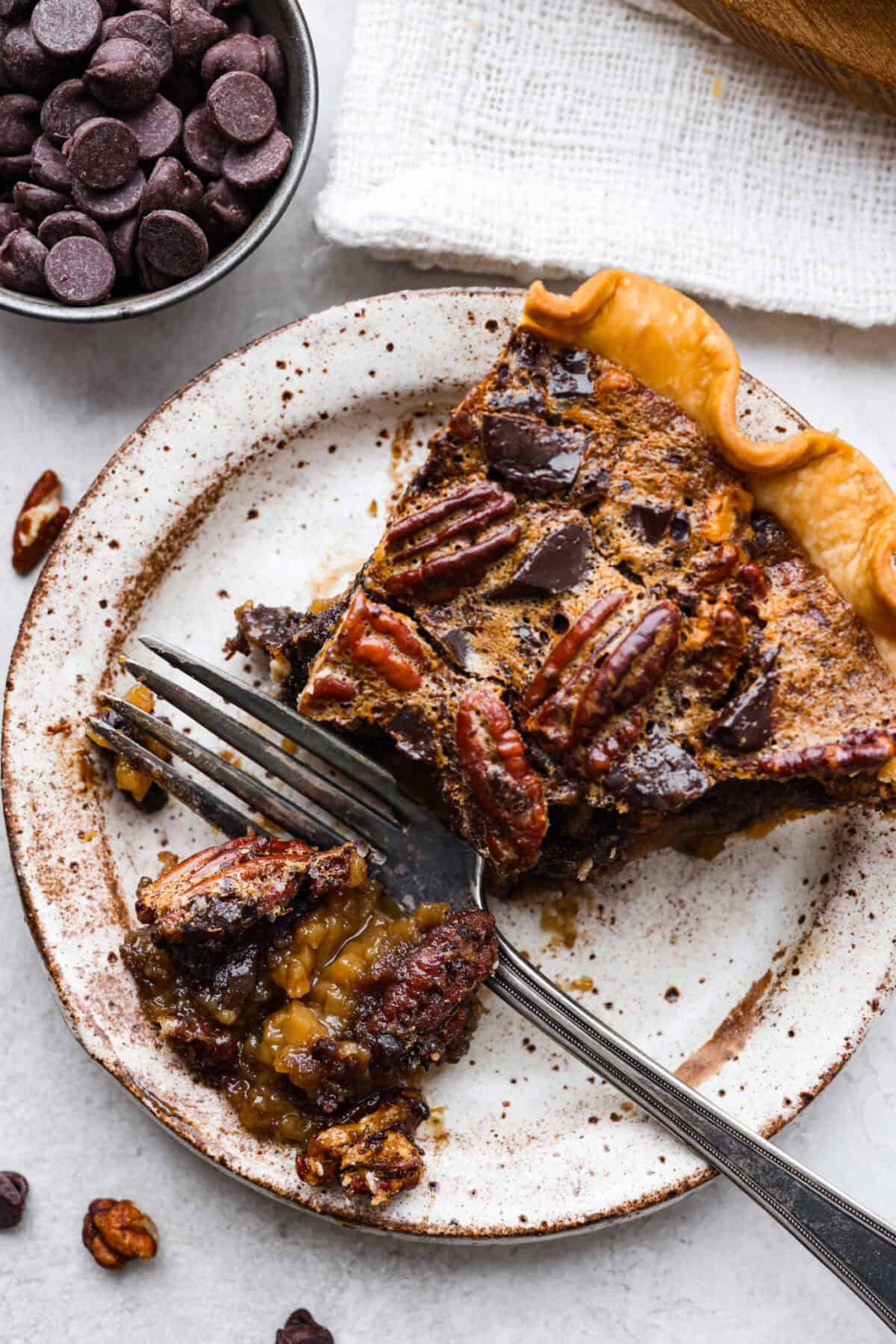 Overhead shot of a plated slice of chocolate pecan pie. 