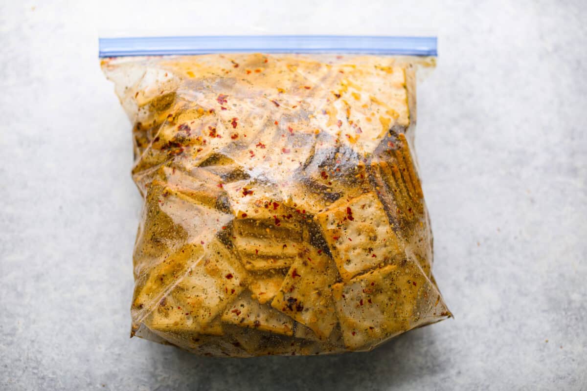 Overhead shot of a ziplock bag with sauce ingredients and saltine crackers. 