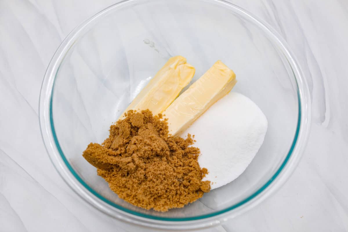 Overhead shot of butter and sugars in a bowl. 