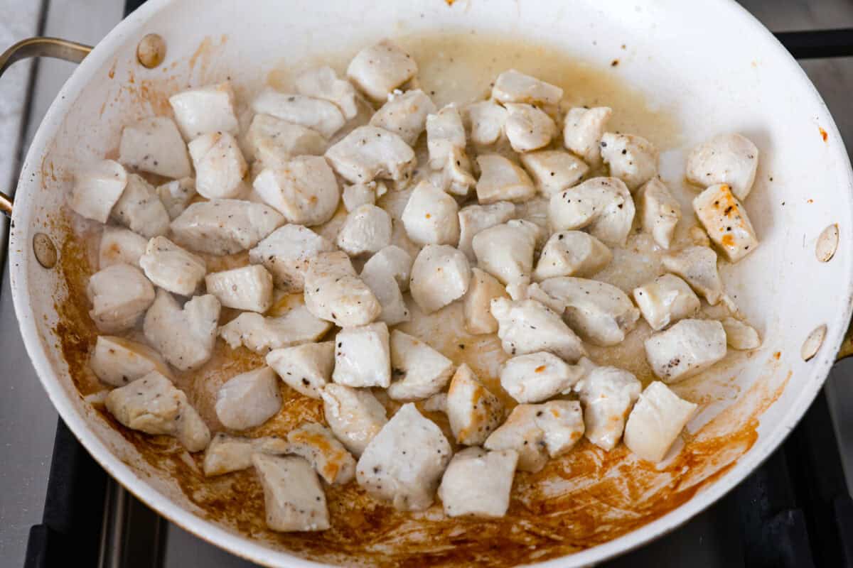 Overhead shot of chicken cooking in a skillet. 