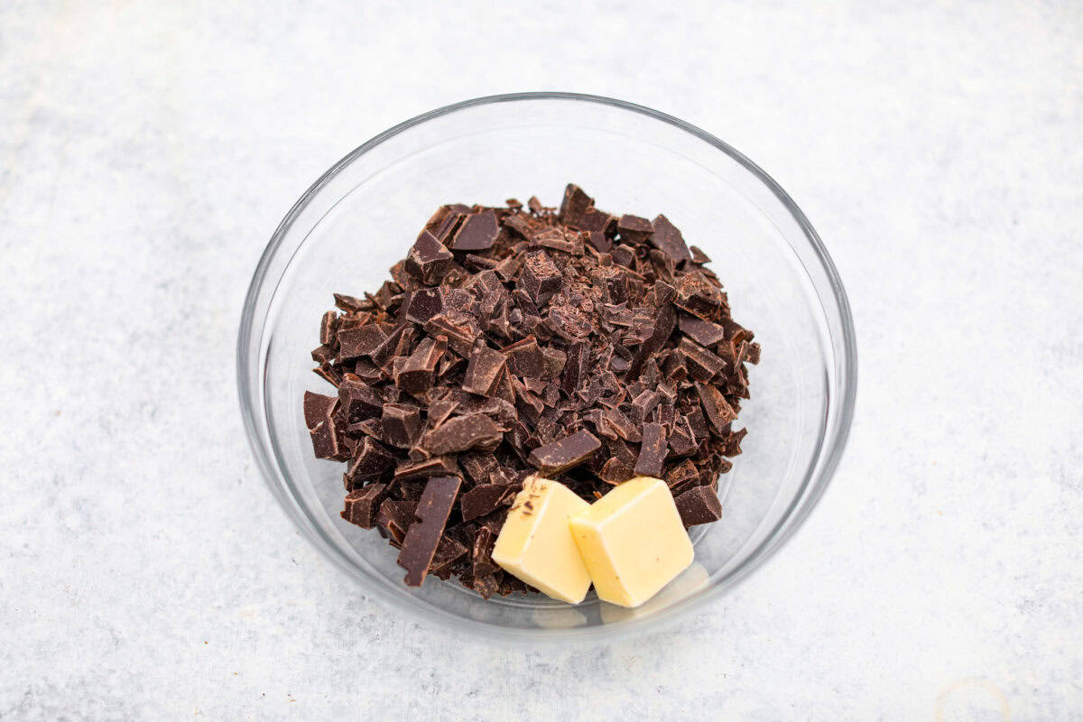 Overhead shot of chocolate and butter in a glass bowl. 