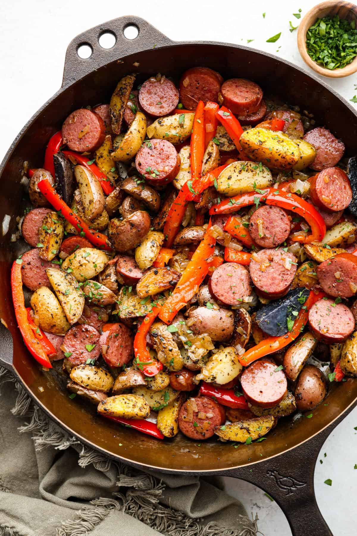 Top view of sausage and potato skillet in a cast iron skillet.