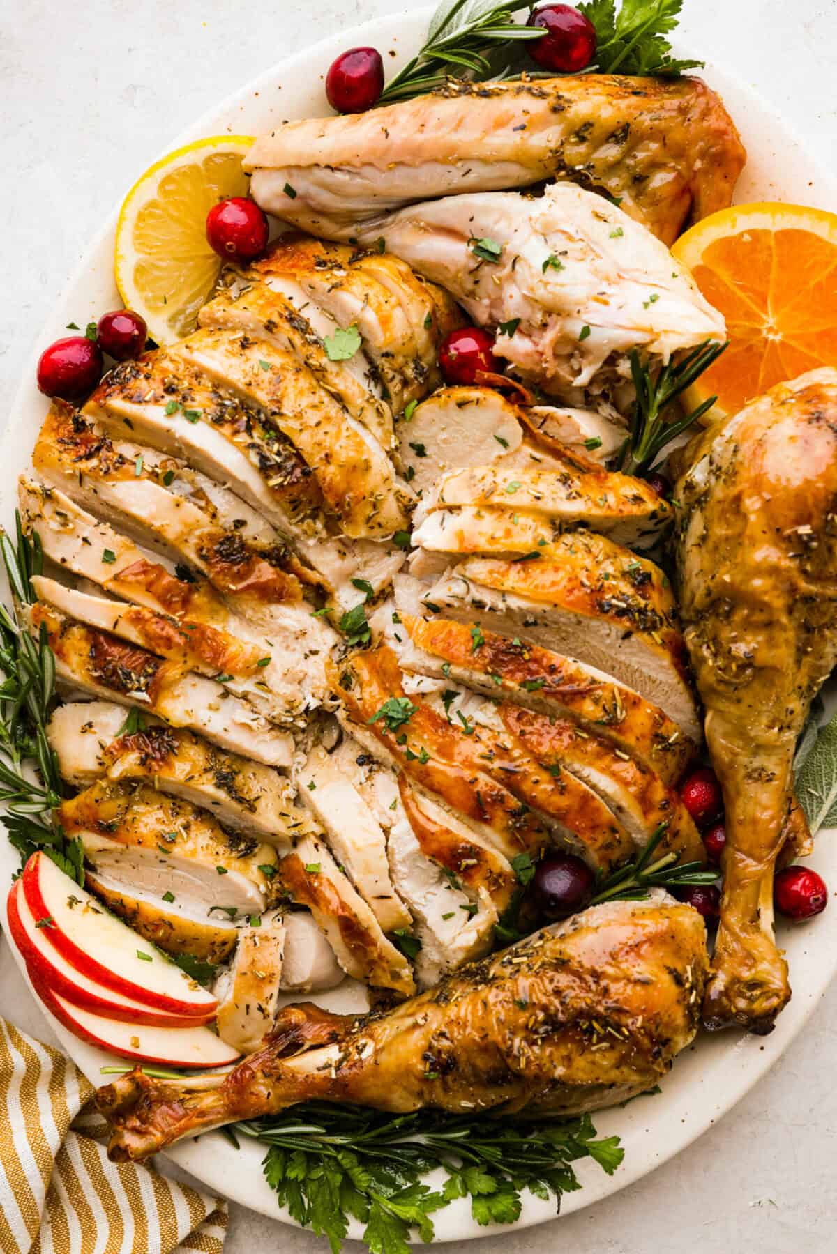 Top view of the carved oven roasted turkey on a platter.