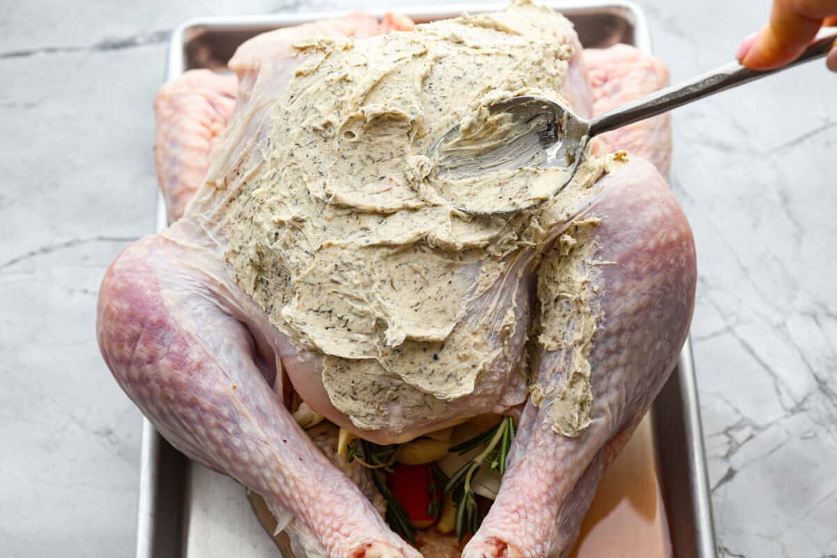 Seventh photo of the herb butter spreading on the turkey.