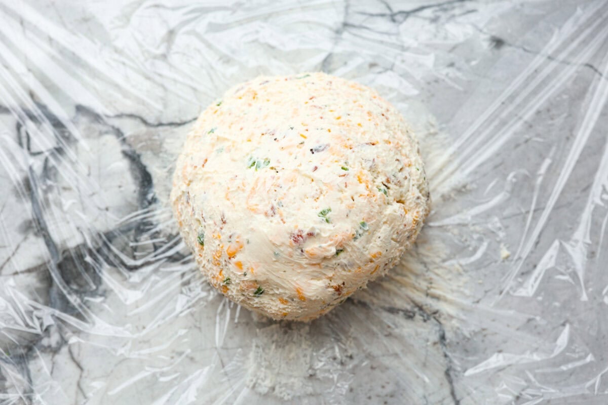 Fourth photo of the cheese ball formed into a ball.