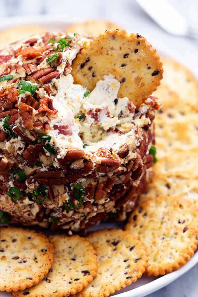 Close view of bacon ranch cheese ball with a crackers dipping.