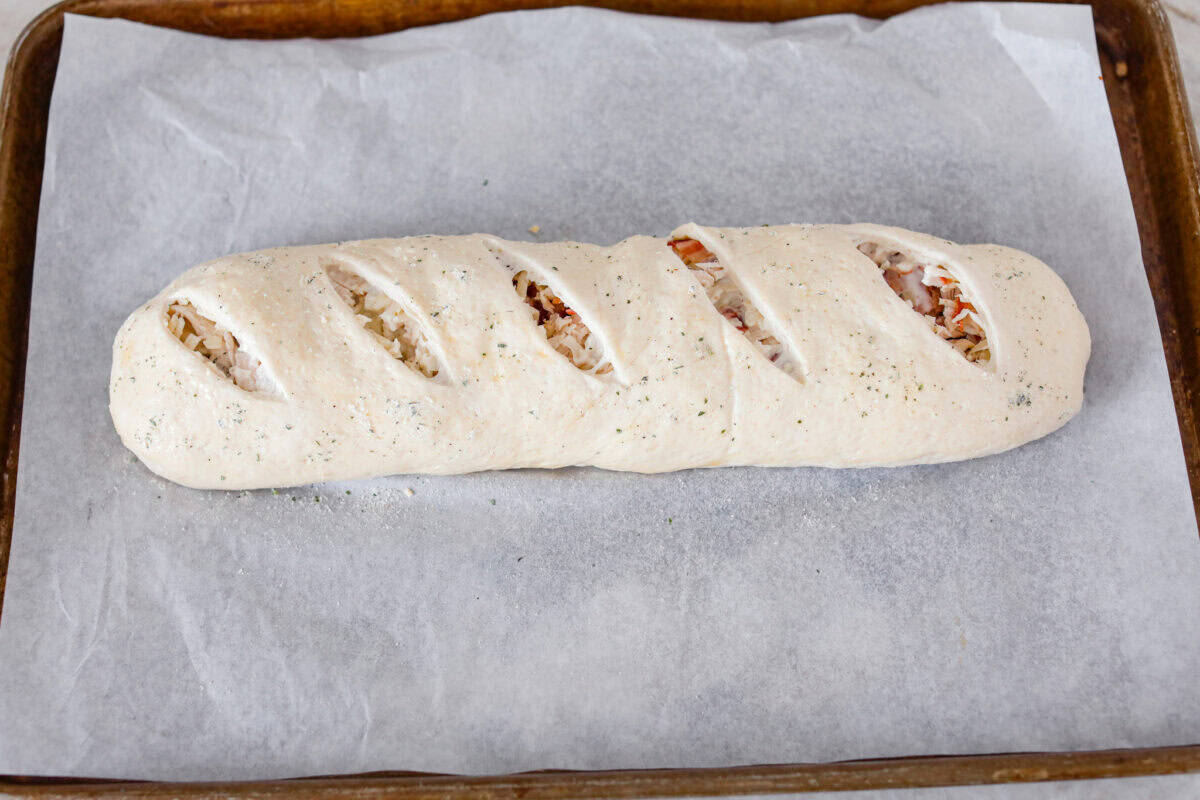 Angle shot of the Stromboli covered and cut and ready to go in the oven. 