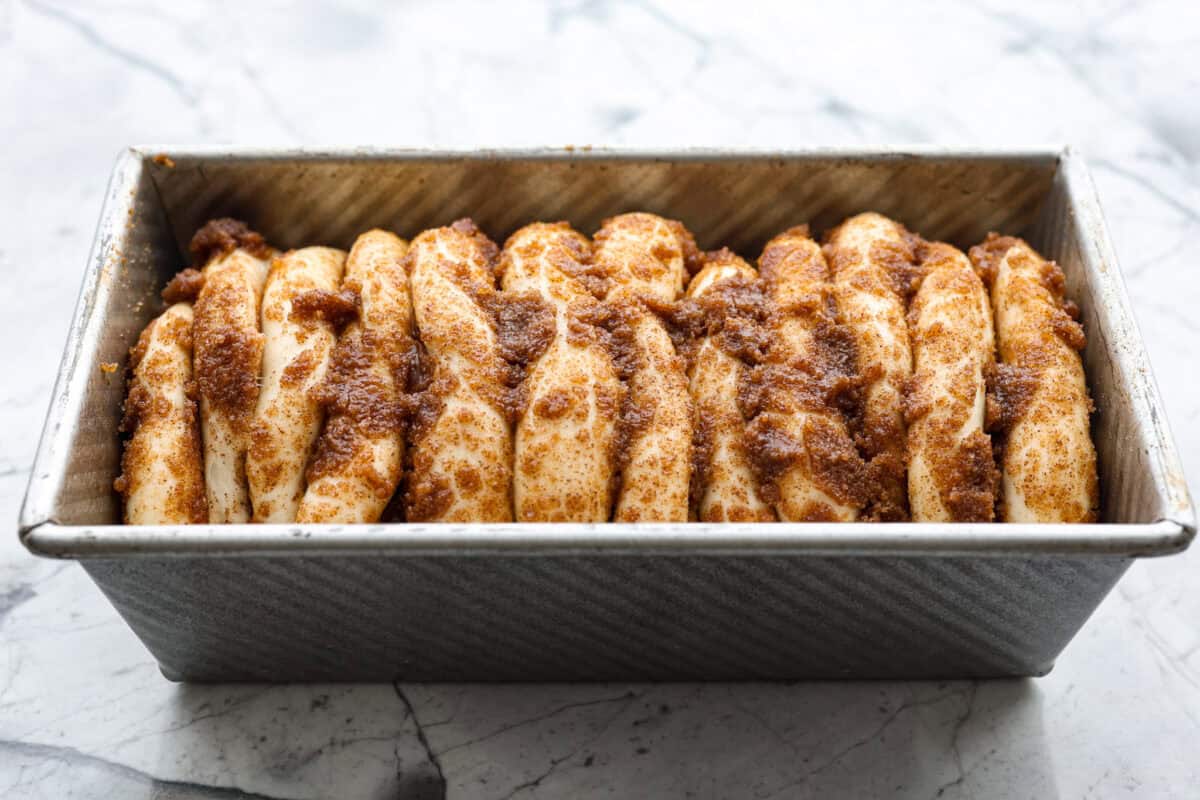 Overhead shot of the cinnamon pull-apart bread rising in the loaf pan. 