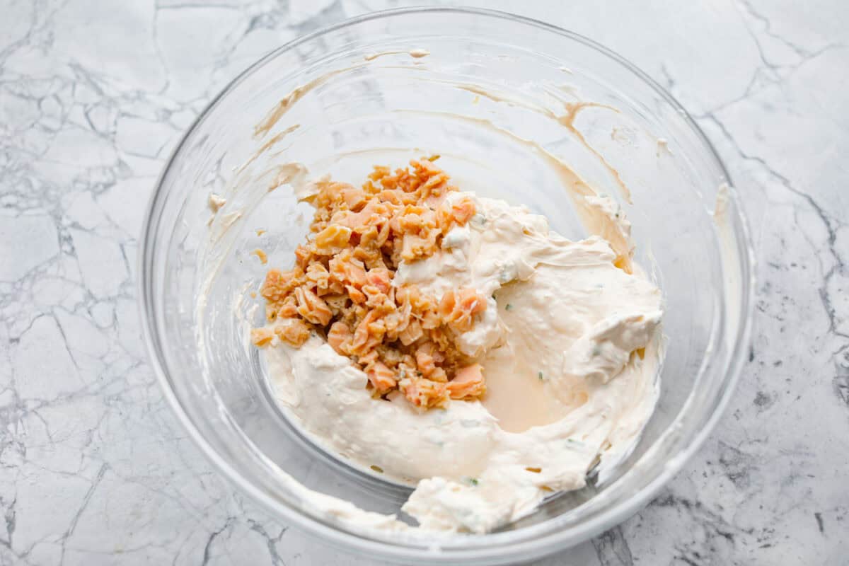 Overhead shot of dip ingredients mixed together with clams on top. 