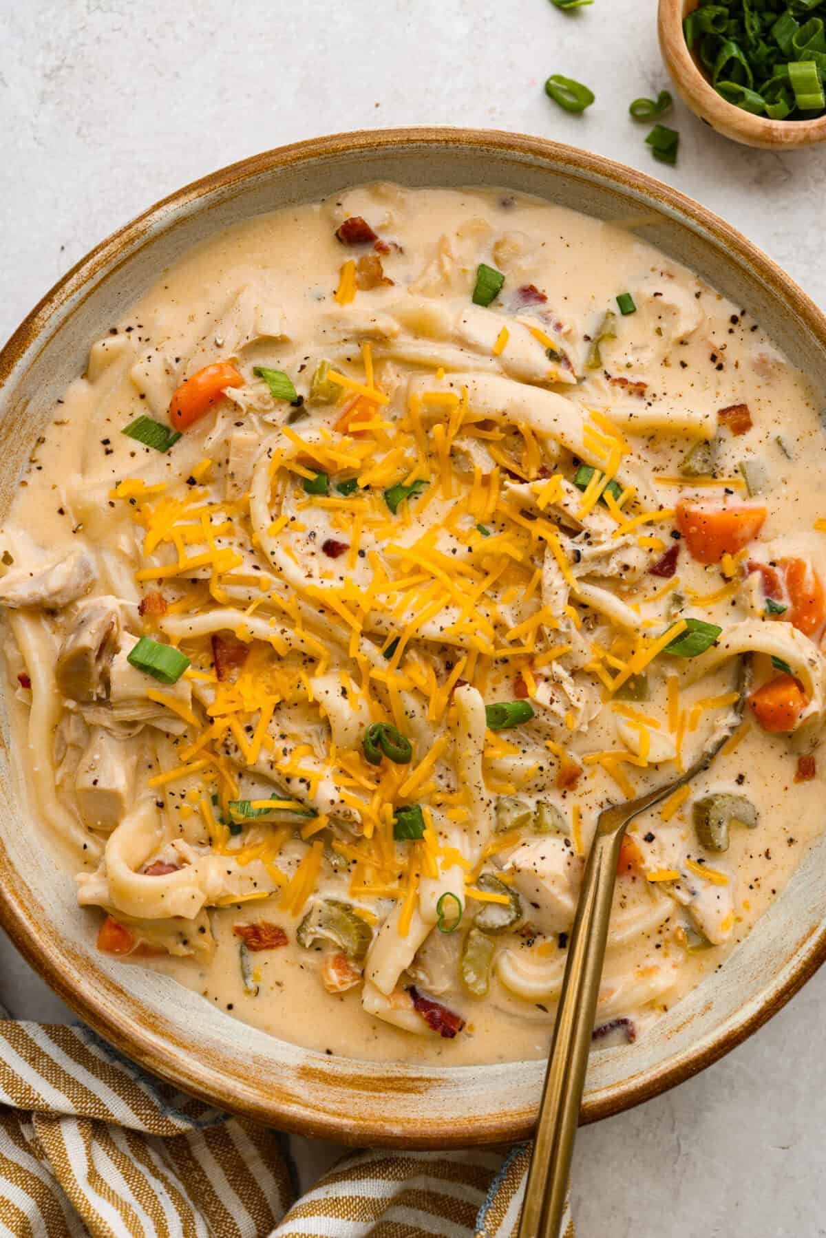 Overhead shot of a bowl of crack chicken noodle soup. 