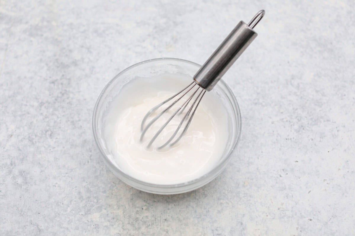 Overhead shot of the glaze ingredients whisked together in a bowl. 