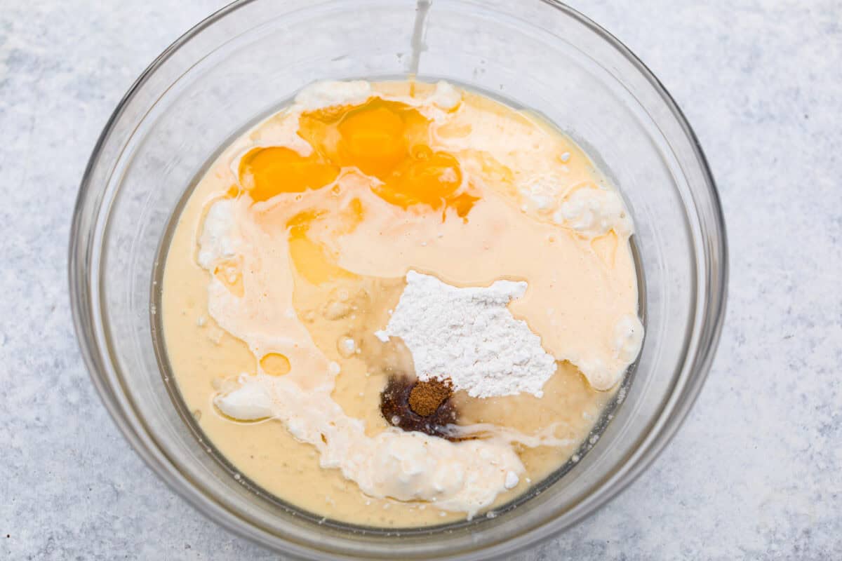 Overhead shot of cake batter ingredients in a mixing bowl. 