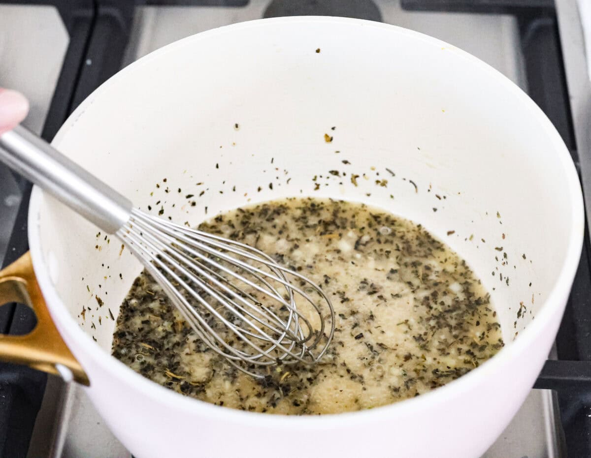 Angle shot of the butter and garlic with Italian seasoning mixed in. 