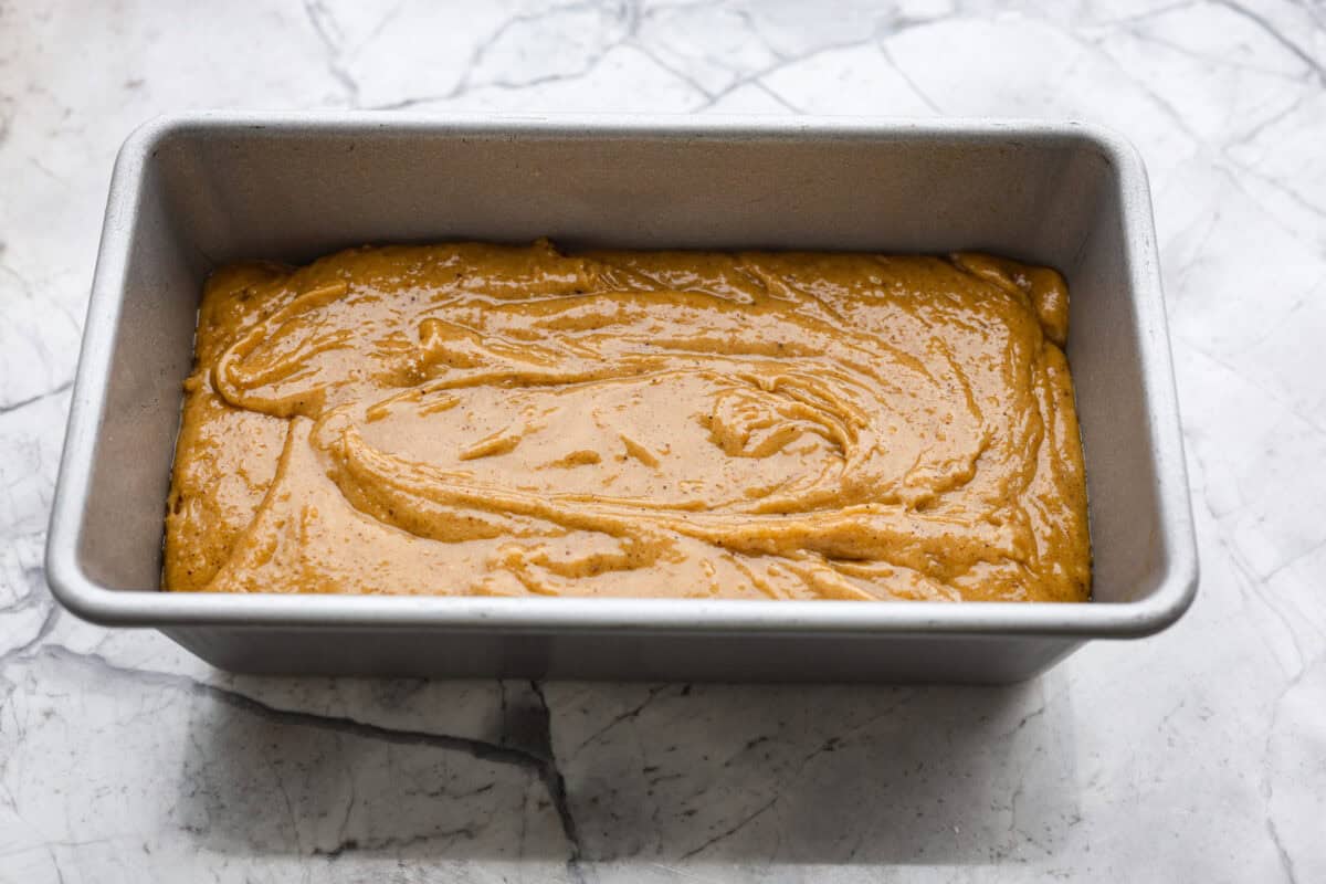 Overhead shot of gingerbread loaf batter in a loaf pan. 