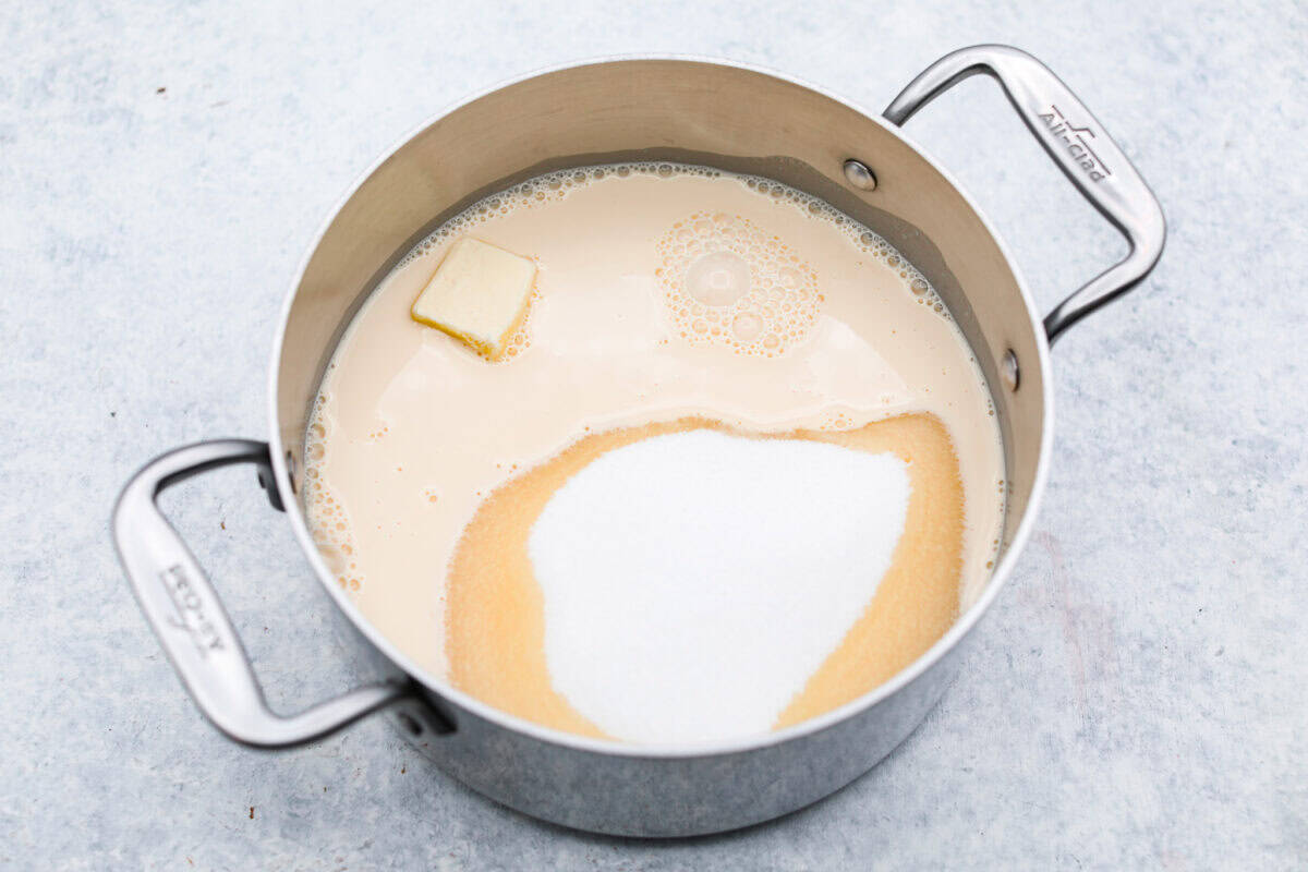 Overhead shot of the sugar, butter, salt, and evaporated milk in a saucepan. 