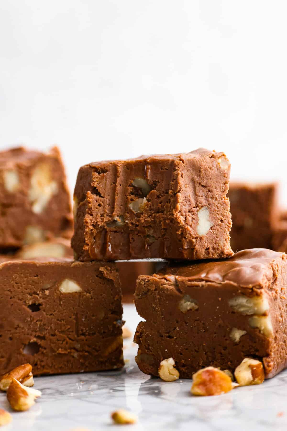 Close up shot of million dollar fudge stacked with a bite taken out of one. 