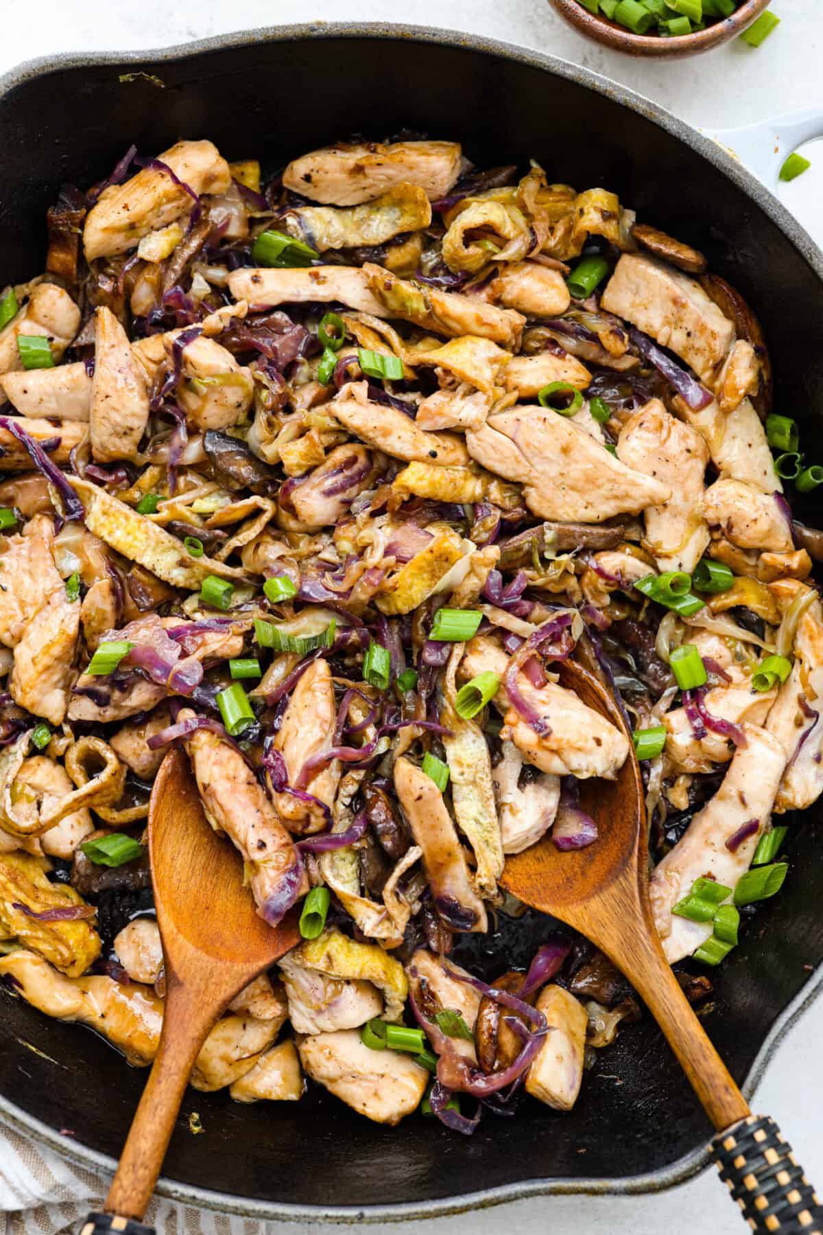 Overhead shot of Moo Shu chicken in a skillet. 