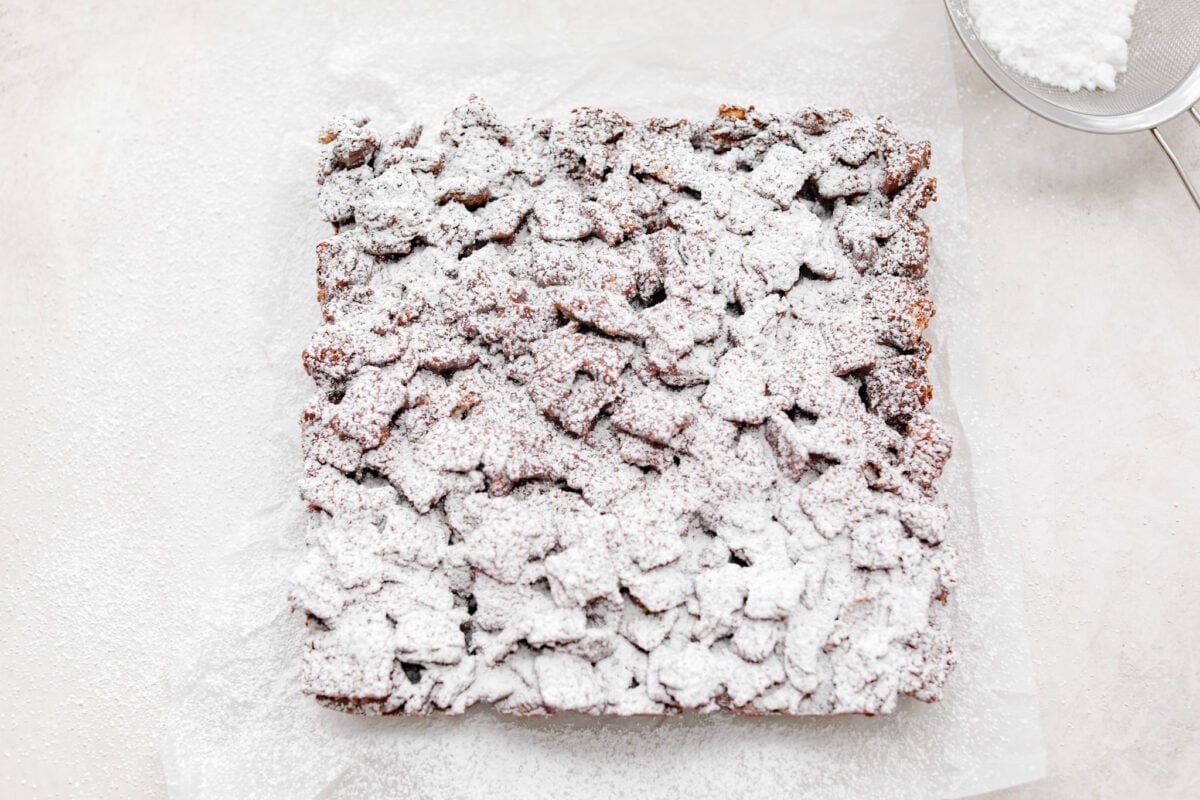 Overhead shot of muddy buddy bars dusted with powdered sugar. 