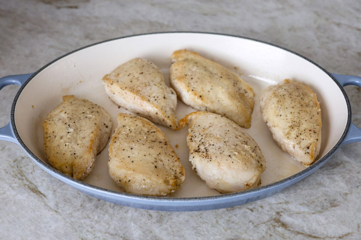 Angle shot browned chicken in a baking dish. 