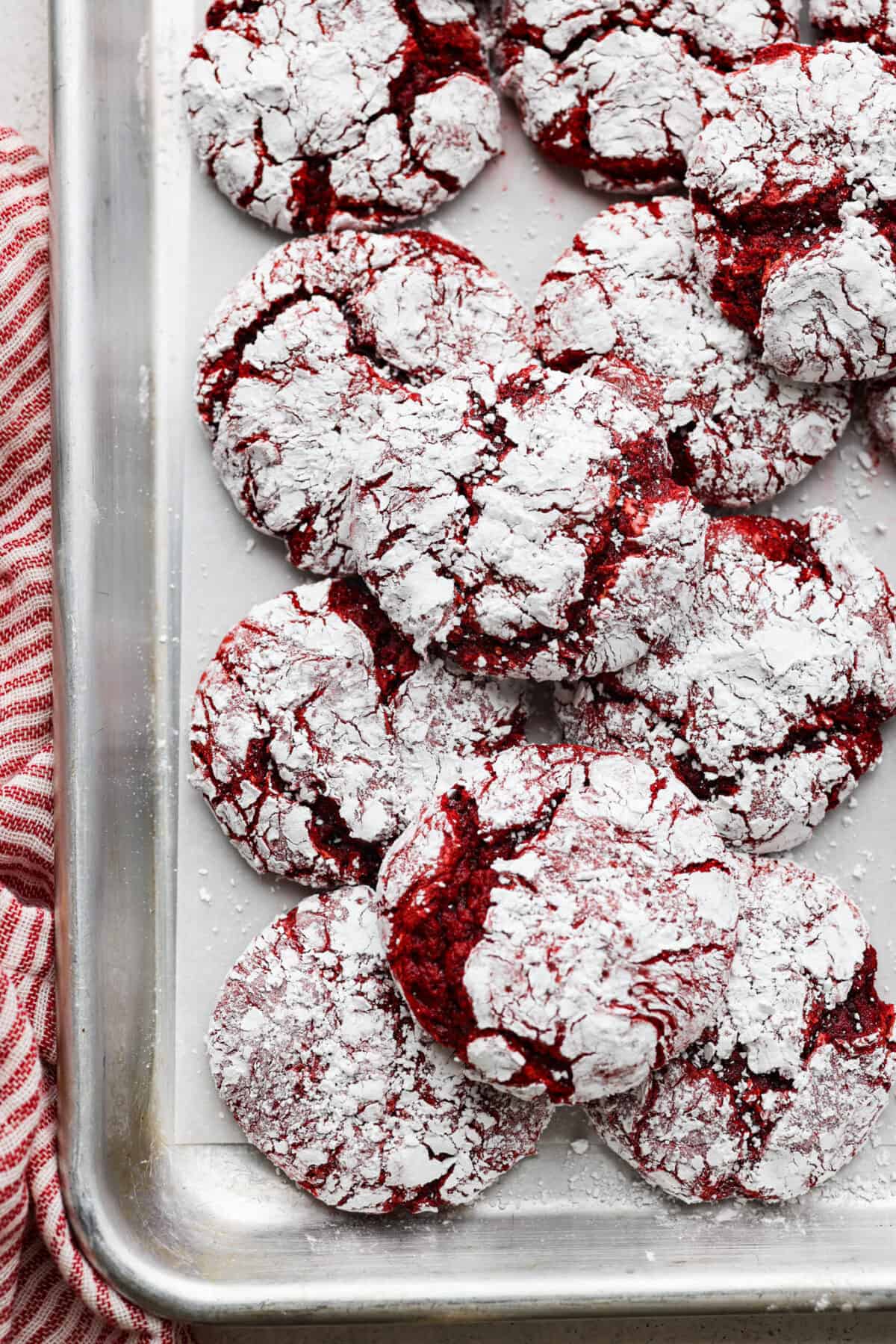 Overhead shot of cool whip cookies stacked on a baking sheet. 