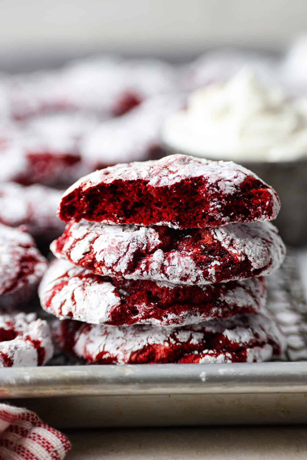 Side shot of a stack of cool whip cookies on a baking sheet. 