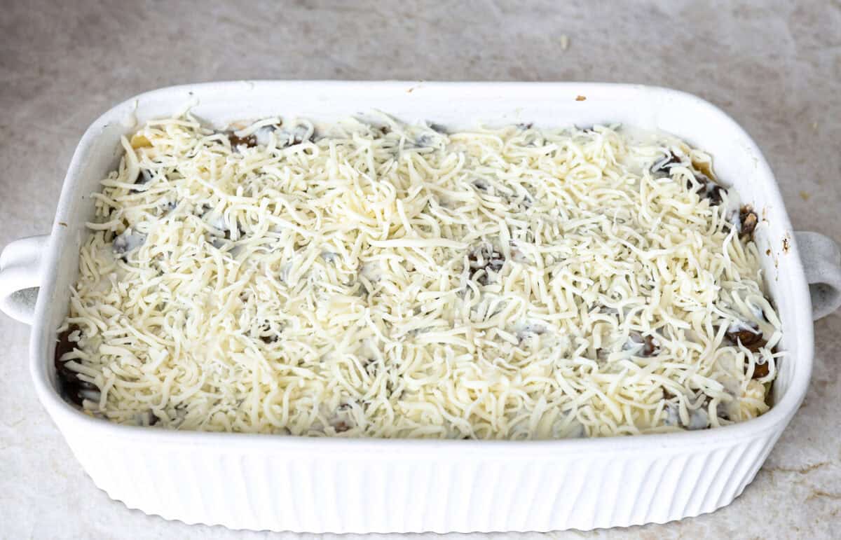 Angle shot of the mushroom lasagna topped with cheese. 