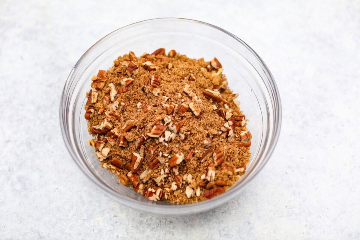 Overhead shot of cinnamon, brown sugar and pecans mixed in a bowl. 