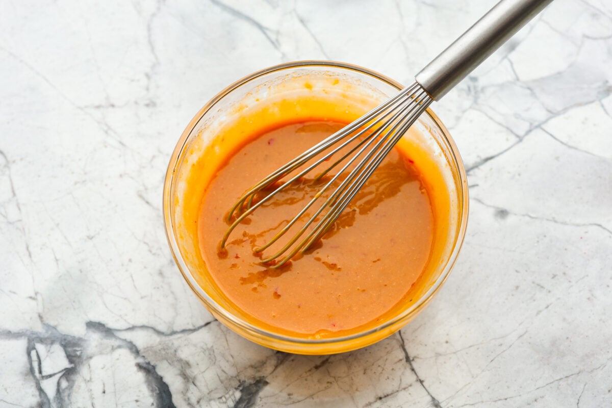 Overhead shot of whisked up Thai peanut dressing in a bowl. 