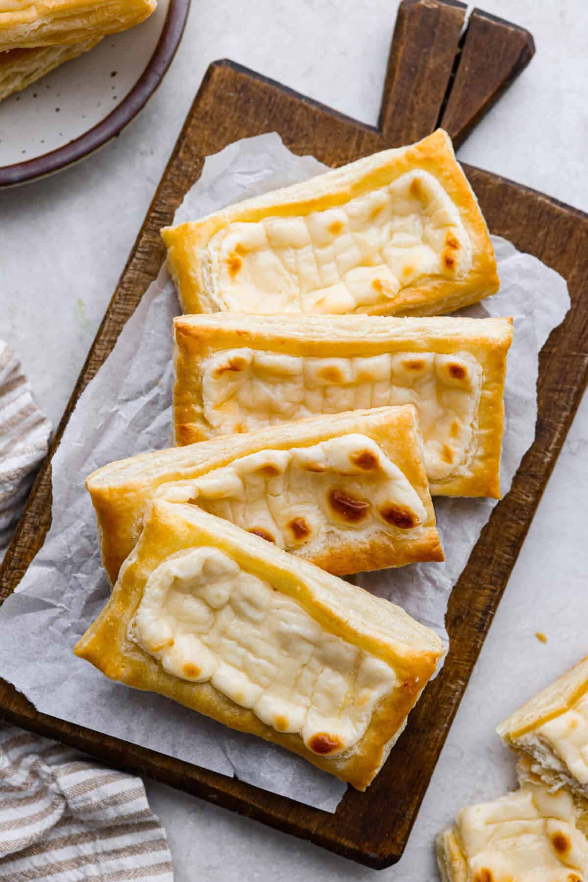 Overhead shot of Starbucks cream cheese danishes on a cutting board. 