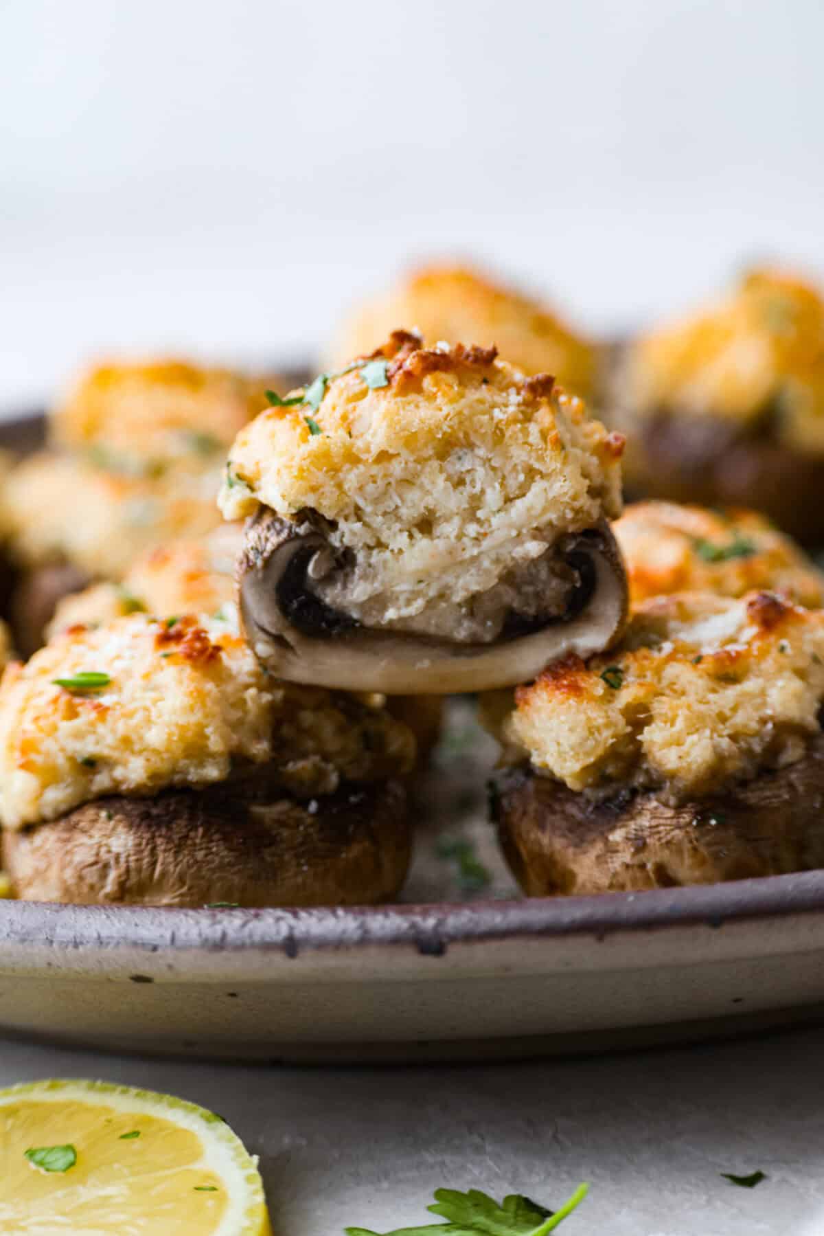 Side shot of a crab stuffed mushroom cut in half. 