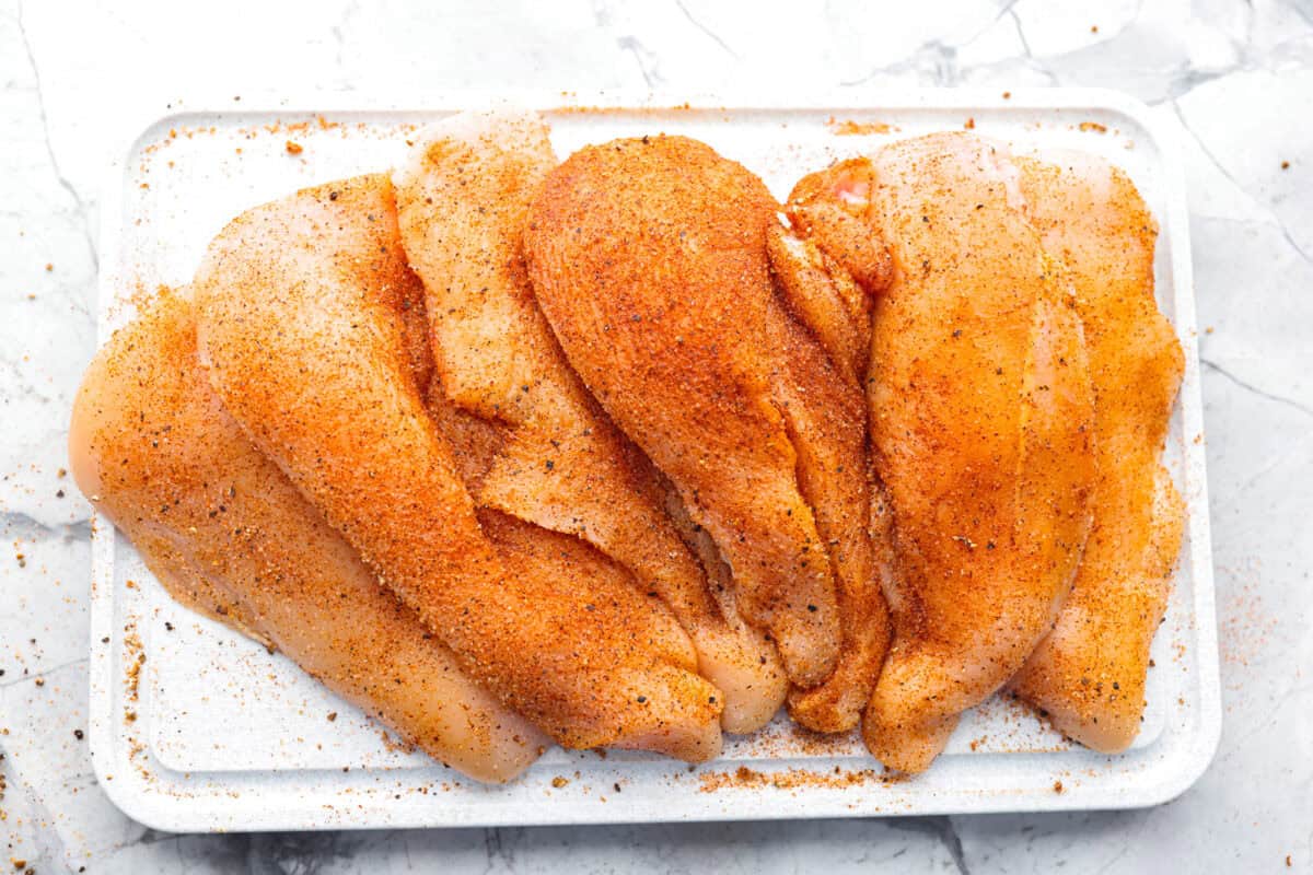 Creamy Cajun Chicken is the perfect combination of bold, zesty flavors and rich, velvety sauce. Juicy, tender chicken is coated in a perfectly spiced Cajun seasoning and simmered in a luscious, creamy sauce that’s packed with flavor. Overhead shot of chicken cutlets covered in seasoning.