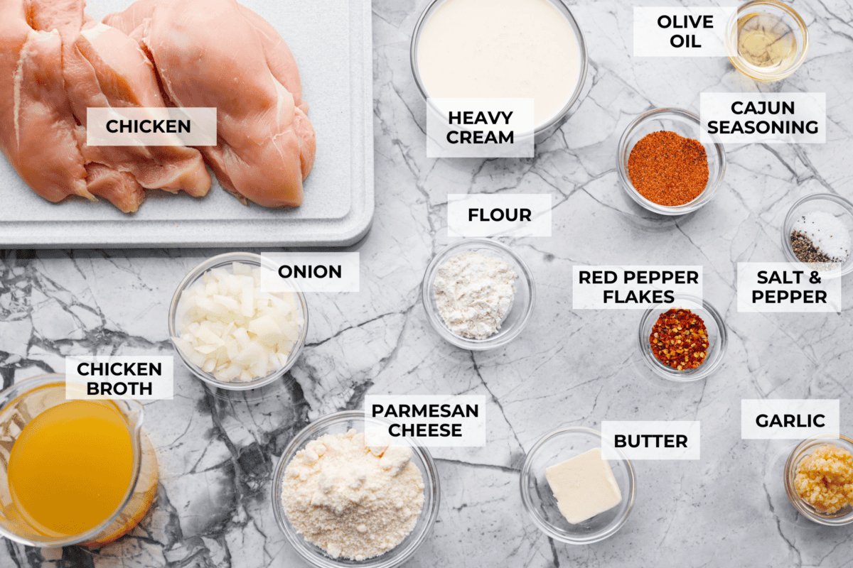 Creamy Cajun Chicken is the perfect combination of bold, zesty flavors and rich, velvety sauce. Juicy, tender chicken is coated in a perfectly spiced Cajun seasoning and simmered in a luscious, creamy sauce that’s packed with flavor. Overhead shot of labeled ingredients.